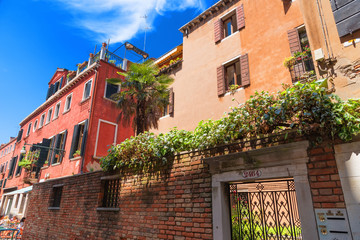 Beautiful venetian street with old houses in a sunny summer day.