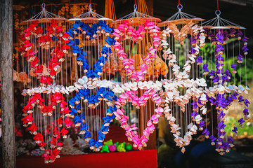 Market stall of multi-colored bright Decoration with many different seashells and snails on the wall
