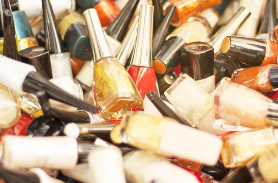 Bottles for nails, a few pieces lie in a small heap