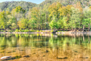 New River Gorge water river lake during autumn golden orange foliage in fall by Grandview with peaceful calm tranquil day