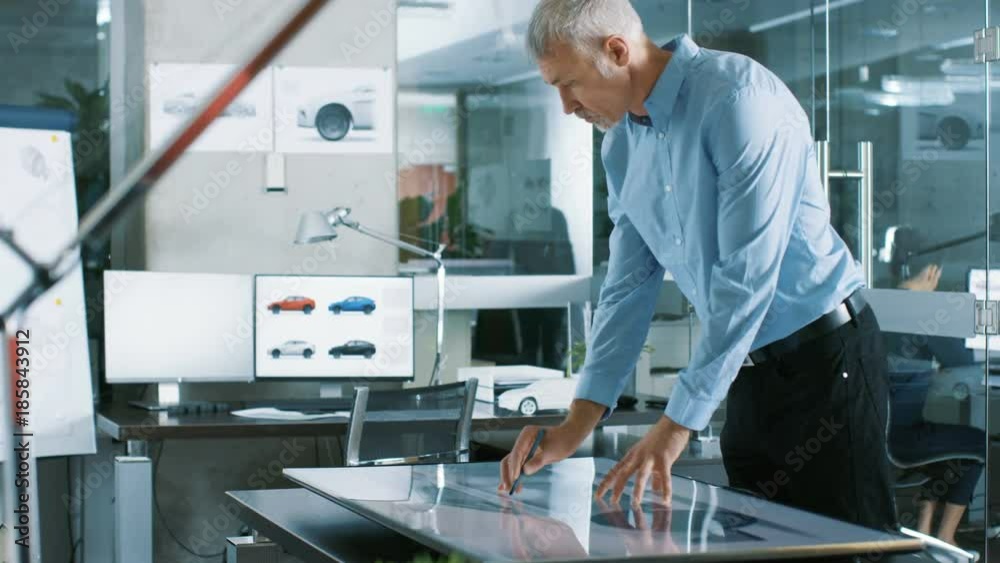 Poster experienced automotive designer works with digital display graphics tablet touschreen table, drawing