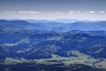 Green forests, meadows, gentle slopes and country roads in Slovenske Rudohorie Slovak Ore Mountains at Roznava and Dobsina in a sunny spring day from Kralova Hola peak, Low Tatras, Slovakia, Europe © nogreenabove2k