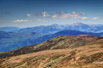 Barren Low Tatra main ridge with stratified rocks, in the background its highest peak Dumbier under cumulus clouds in a sunny spring day from Kralova Hola, Nizke Tatry National Park, Slovakia, Europe © nogreenabove2k