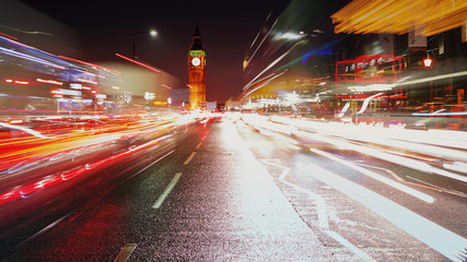 A long exposure night shot showing car light trails, the Westminster area and the Big Ben in London, England, UK