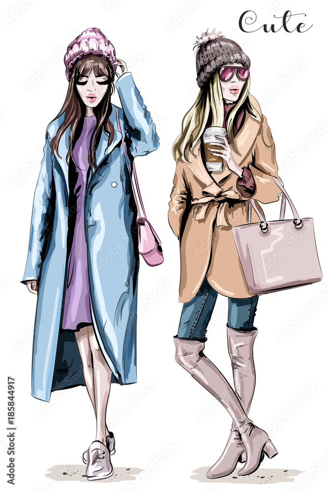 Wall mural Two fashion women. Hand drawn stylish beautiful women in winter clothes. Fashion winter outfits. Sketch.