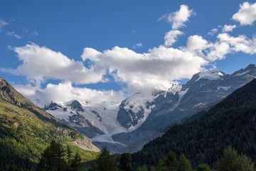 Fototapeta na wymiar mountain peaks covered with snow, beautiful alpine landscape with glacier, blue sky with clouds