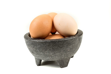 Farm fresh eggs in a bowl on a white background