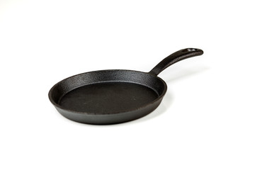 Black cast iron frying pan on a white background