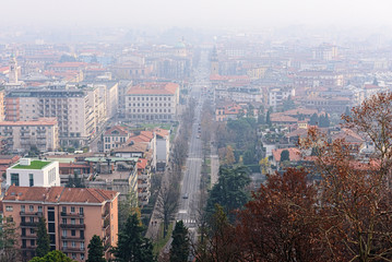 Aerial view on central street of foggy Bergamo town, Italy