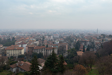 Fototapeta na wymiar Aerial panoramic view on foggy Bergamo town in northern Italy