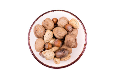 Mixed nuts in shell  in a bowl on a white background