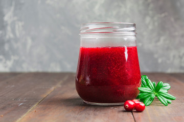 Cranberry sauce in glass jar with copy space