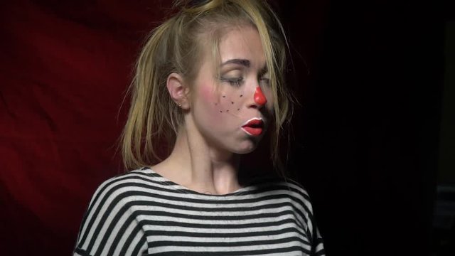 Blonde in a clown makeup sneezes funny