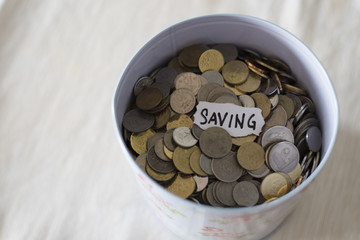 coins in tin with a notes written by the word 