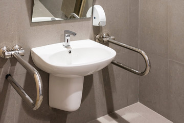 Interior of bathroom for the disabled or elderly people. Handrail for disabled and elderly people in the bathroom