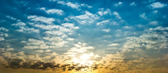 Naklejka na ściany i meble Panorama sky full with fluffy clouds and sunlight