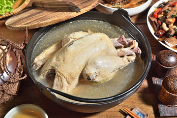Bowl of  chicken soup on wooden table . 