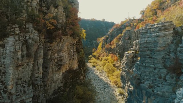 Aerial flight inside a gorge during sunrise or sunset, at Zagorochoria of Northern Greece