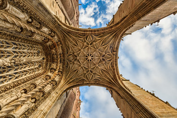Closeup view of a medieval cathedral's entrance from ground up