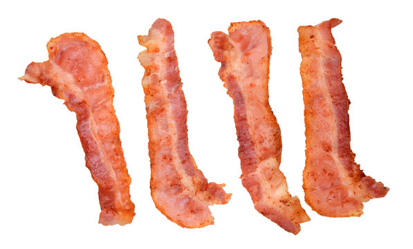 Four cooked, crispy fried bacon isolated on a white background. Good for many health and cooking inferences.