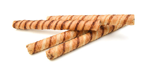 Wafer roll with chocolate and cocoa coating on a white background
