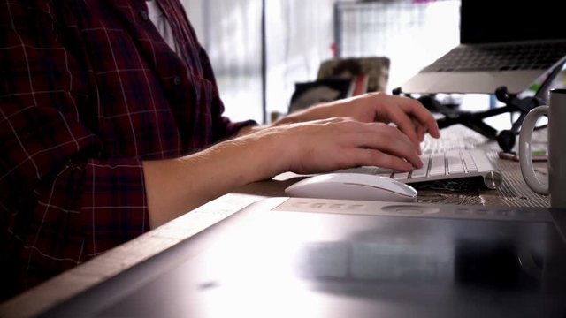 Close up hand male typing on white keyboard