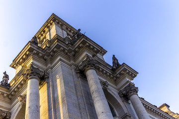 Detail of the facade of the Reichstag building. Blue sky and grey stones. Berlin, Germany .