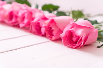 pink rose in vase on wood background