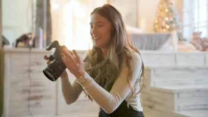 Young beautiful photographer with the professional camera. Shooting, laughing and having fun. Smile - Powered by Adobe