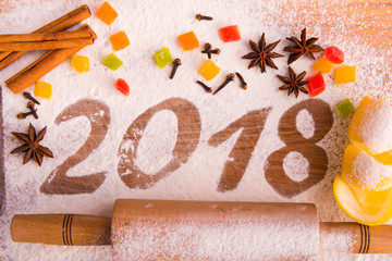 2018 inscription on a board with flour