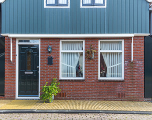 Typical Dutch village houses facade. Beautiful and authentic style at Volendam. North Holland, Netherlands..