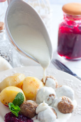 Creamy sauce with meatballs, selective focus