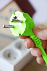 green energy - electrical plug and socket - save up money for electricity and use ecolocogical source of energy