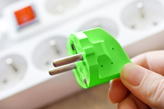 green energy - electrical plug and socket - save up money for electricity and use ecolocogical source of energy