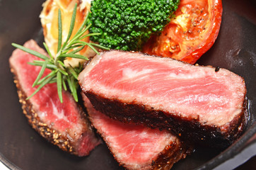 Close up of rib eye steak with vegetables