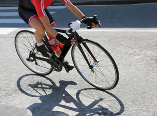 Fototapeta na wymiar fast cyclist over her bike during the curve