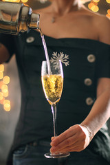 A girl pours a drink on a holiday. Christmas concept