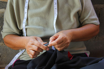 Women are sewing, tribal dress, Phuthai dress