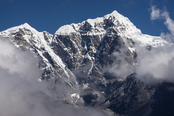 Naklejka premium Taboche mountain peak above the clouds, Everest region, Nepal
