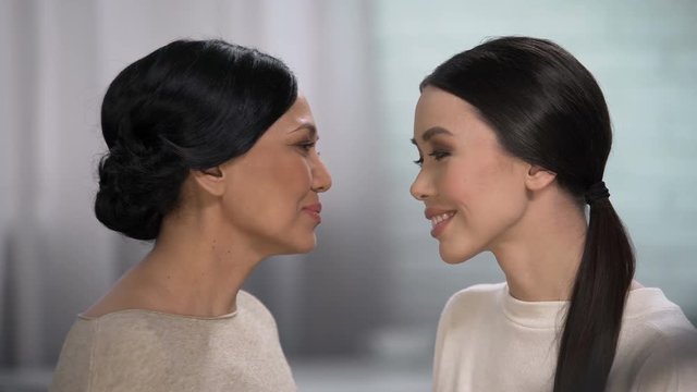 Mother feels happiness for her daughter, expressing love, touching forehead