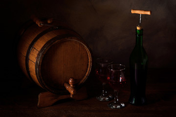 a small wooden wine bar, barrel on the legs and a wooden crane on a wooden background with a glass...