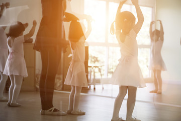 asian kid practice ballet dancing to balance body activities with trainer classic activities for kids  © Yanukit