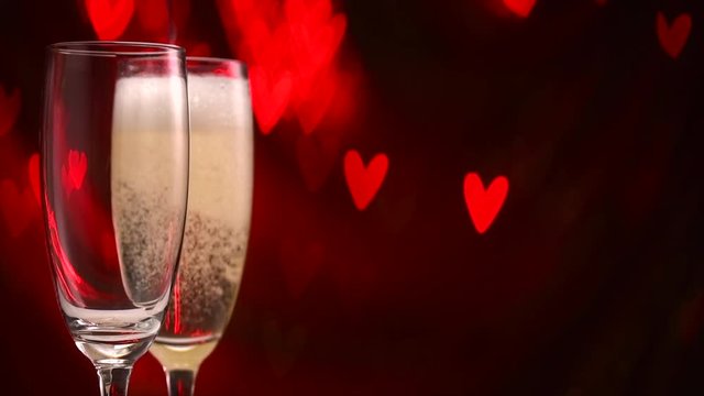 Valentine's Day celebration. Champagne pouring over holiday blinking background. Slow motion 4K UHD video footage. 3840X2160