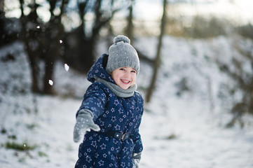 Fototapeta na wymiar Cute little girl having fun outdoors on winter day.