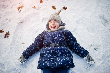 Cute little girl having fun outdoors on winter day.