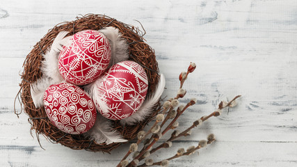 Pysanky, decorated Easter eggs in the nest - obrazy, fototapety, plakaty