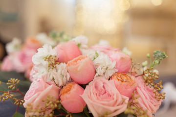 Beautiful wedding bouquet and gold rings