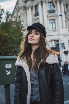 Woman in stylish cap on street