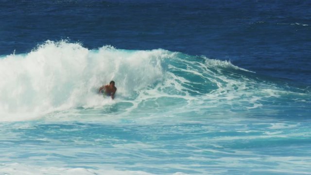 a body board rider gets a tube ride at the surf break, pipeline
