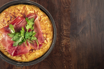 Overhead closeup photo of Spanish tortilla with copy space